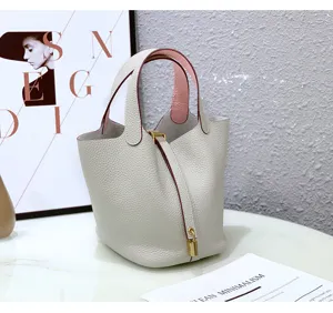 Detail view of genuine leather bucket handbag, top layer cowhide vegetable basket bag for women.
