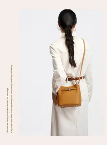 Stylish brown leather bucket bag with metal lock detail, versatile crossbody handbag for women.