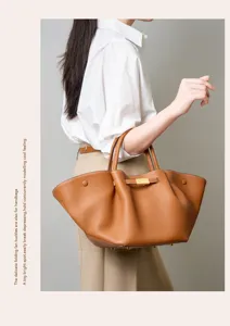 Spacious genuine leather commuting shoulder bag with chic folding fan side design for daily wear.