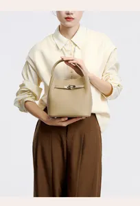 Detailed view of the premium leather bucket bag with metal lock closure and top handle design.
