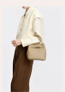 Elegant leather bucket handbag with metal turn-lock closure for women daily commute style.