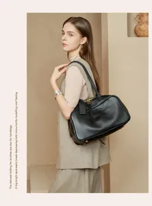 Large capacity black leather Boston handbag for women, stylish commuter shoulder bag.