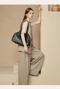 Black leather boston shoulder bag detail scene, elegant professional commuter handbag.