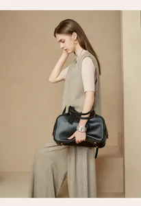 Large capacity black leather boston bag, stylish top handle shoulder bag for women daily commute.