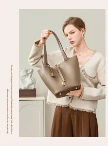 Genuine leather bucket bag for women, premium commuter handbag with lock and tote design.