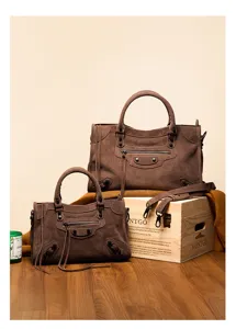 Brown suede motorcycle shoulder bag set, vintage style top handle handbag with tassels and studs.