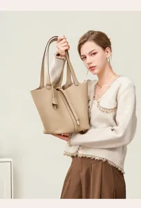 Genuine leather bucket bag for women, premium commuter shoulder handbag with top handle.