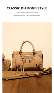 Detailed view of stylish suede handbag featuring classic hardware, tassels and premium texture.