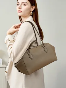 Detailed view of the elegant brown leather shoulder bag, showcasing premium texture and design.