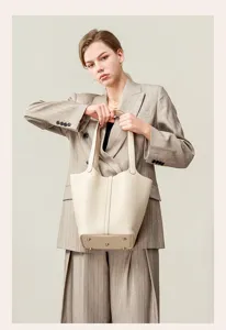Top layer cowhide bucket bag detail view, premium leather shoulder handbag for women daily commute.