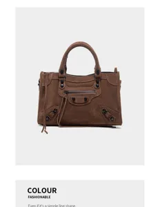 Brown suede motorcycle bag detail, classic hardware studs and zipper pocket design.