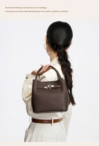 Detail view of the premium leather bucket bag with elegant metal turn-lock and top handle.