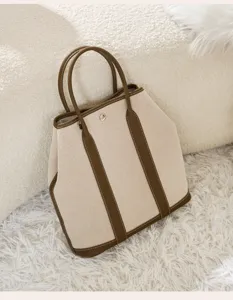 Vertical canvas tote bag with leather handles, large capacity shoulder handbag for women stylish.