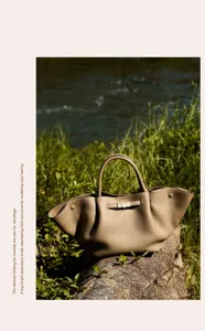 Detail view of the elegant leather commute handbag with distinctive fan-folding design.