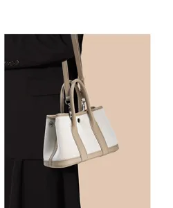 Detailed close-up view of premium canvas and top layer cowhide garden tote bag with strap.