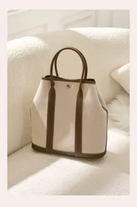 Vertical canvas leather tote bag, stylish large capacity shoulder handbag for daily use.