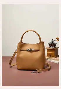 Stylish leather bucket bag for women, commuter crossbody handbag with turn-lock strap detail.
