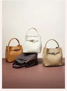 Detailed view of genuine leather bucket bags in four stylish colors with metallic lock strap design.