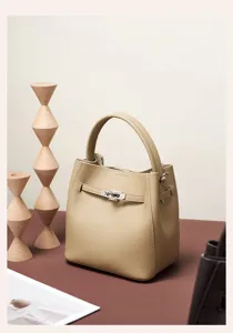 Elegant genuine leather bucket bag in khaki with silver hardware and chic turn-lock closure for women.