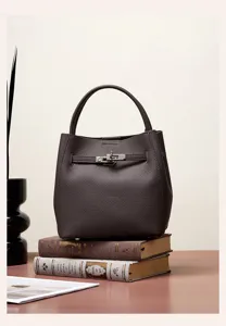 Dark brown genuine leather bucket bag featuring a chic turn-lock strap and top handle design.