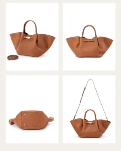 Brown leather handbag detail, featuring double top handles and gold tone metal clasp.