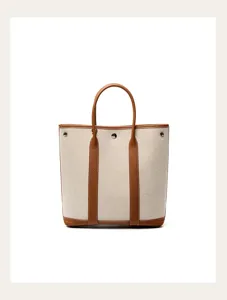Canvas leather tote bag detail, elegant brown leather trim, large capacity shoulder bag.