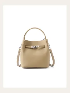 Detailed view of women genuine leather bucket handbag in khaki with top handle and strap.