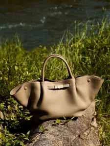 Premium leather tote shoulder bag for women, large capacity commuter handbag with chic metal buckle.