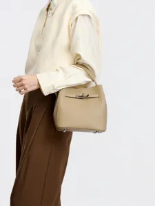 Elegant khaki leather bucket handbag with top handle and turn-lock closure for women daily commuting.