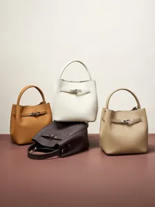 Genuine leather women's bucket bag with top handle and metal lock closure for daily commute.
