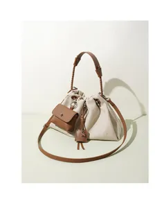 Canvas bucket bag for women, casual drawstring crossbody shoulder handbag with braided handle.