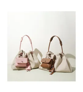 Detailed view of casual women's shoulder bag with braided handle, stylish bucket design.