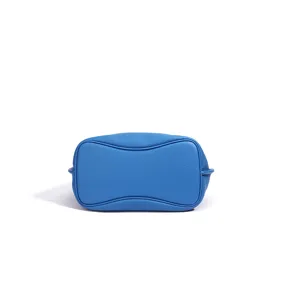 Blue genuine leather bucket bag bottom view, stylish solid color women's messenger bag detail.