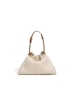 Close-up of beige canvas handbag with brown braided leather handle and stylish drawstring detail.