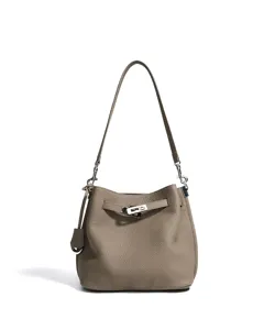 Detail view of taupe leather bucket bag with metallic turnlock and shoulder strap.
