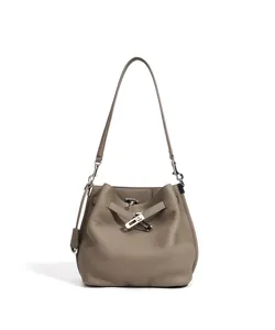 Elegant leather bucket bag with top handle and metal turn-lock closure for women stylish daily use.
