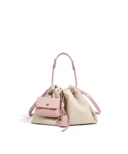 Canvas and pink leather bucket shoulder bag with knotted handle, chic casual crossbody purse.