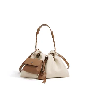 Canvas bucket bag, brown leather trim, casual crossbody handbag, multi-way stylish purse.