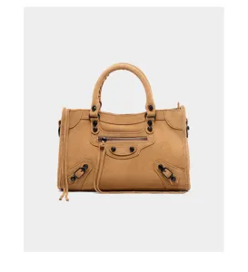 Brown suede motorcycle handbag detail, vintage studded shoulder bag with zipper and tassels.