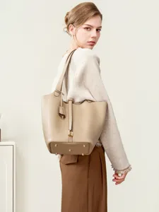 Elegant genuine leather bucket bag with metal lock detail, perfect for daily commuting.