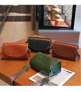Vintage genuine leather shoulder bag for women, retro crossbody purse with wide strap.