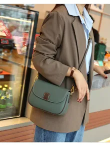 Green leather crossbody bag detail, stylish women shoulder bag with compact design for daily wear.