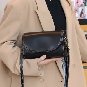 Classic black leather shoulder bag with contrast stitching and metal hardware for women.