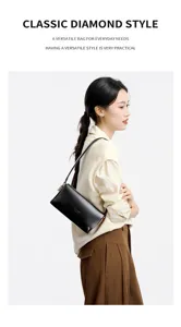 Elegant black leather underarm shoulder bag worn by model, showcasing stylish daily commute look.