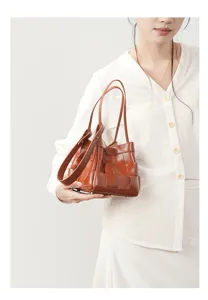 Brown genuine leather woven handbag detail, classic intrecciato design shoulder bag for women.