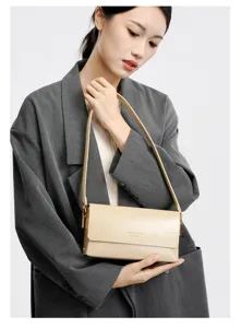Close-up detail of the stylish beige leather shoulder bag with metallic hardware.