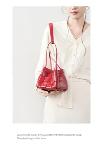 Hand-woven genuine leather shoulder bag for women, elegant red commute handbag with top handle.