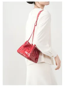 Red woven leather shoulder bag detail, stylish women's genuine leather handbag for daily use.