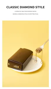 Detail shot of a stylish brown leather shoulder bag with gold chain on a white plate.