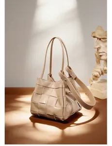Detailed view of the woven leather bucket bag showcasing premium craftsmanship and texture.